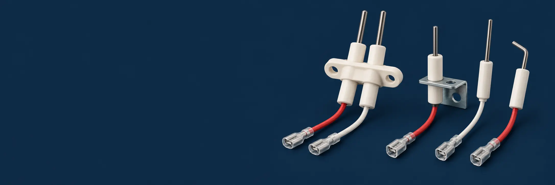 Gas fireplace igniter electrodes with white alumina ceramic bodies, mounting brackets and silicone leads on a dark navy background